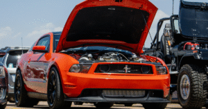 red car with with its hood open